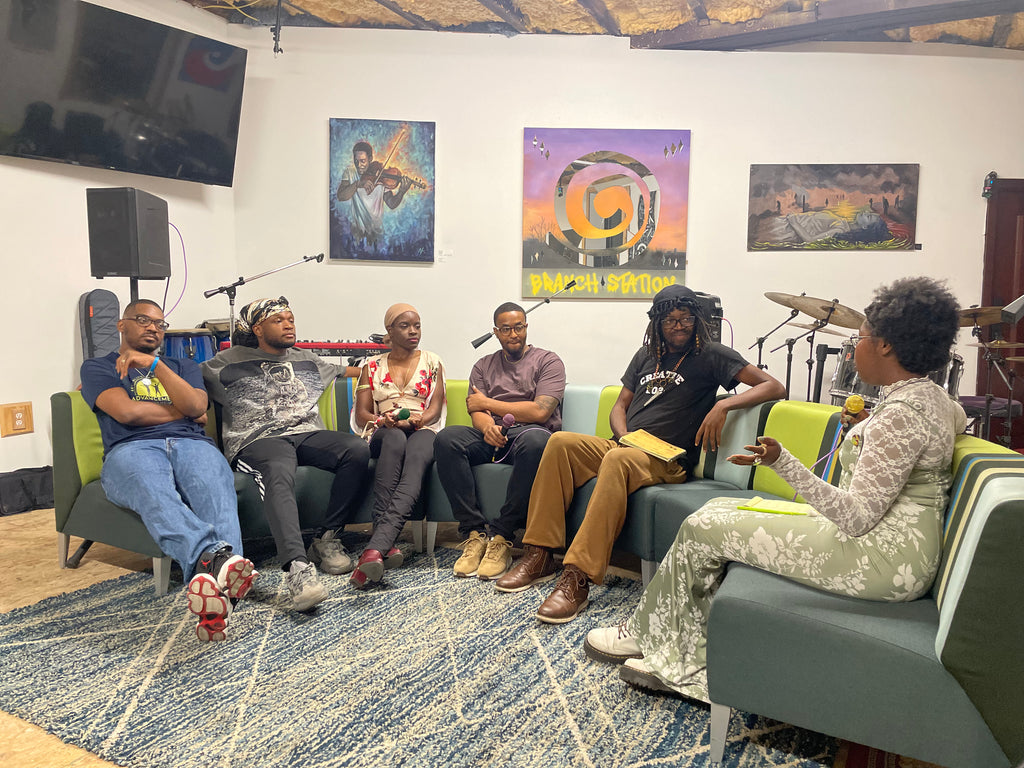 Band members left to right: Chris The Cool, Matt Faturoti, Eyez Josh (on floor), Aleigha Johnson, Tim Spence, Ty Beatz, Sheen Anthony, J Dyl Joi, Devon Reid. Interviewer: Brie Monk